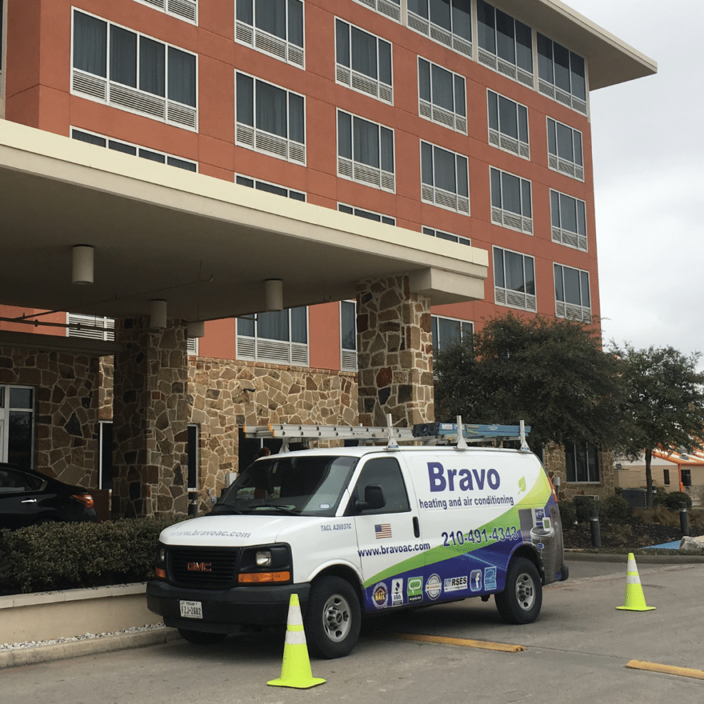 bravo ac van parked outside of commercial building about to perform commercial heating services