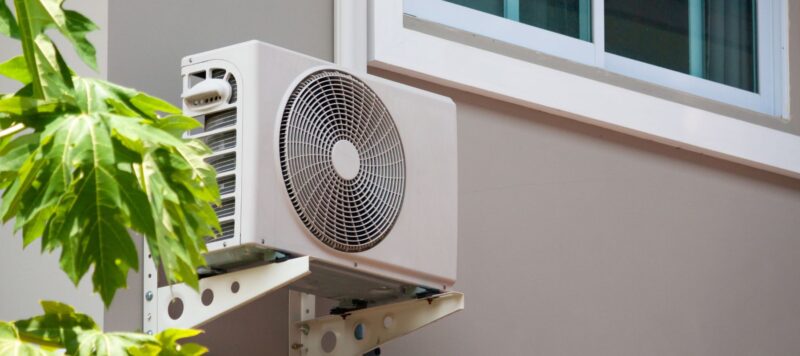 an outdoor ductless ac system installed on the side of a home