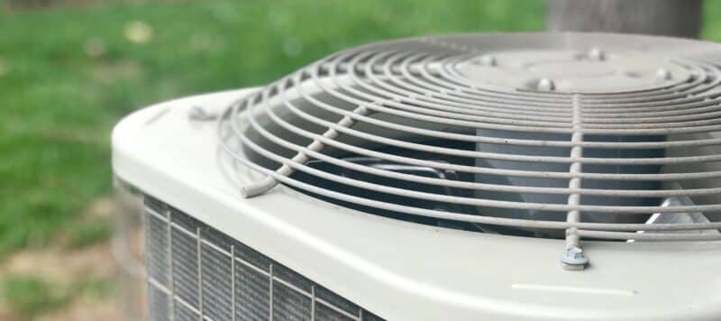 closeup of an outdoor hvac unit top fan cover